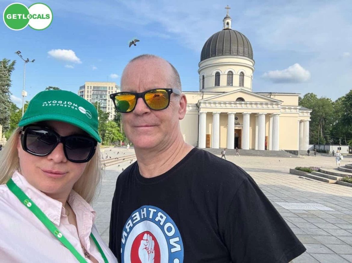 A couple takes a selfie in front of the Nativity Cathedral in Chisinau during a memorable Moldova trip.